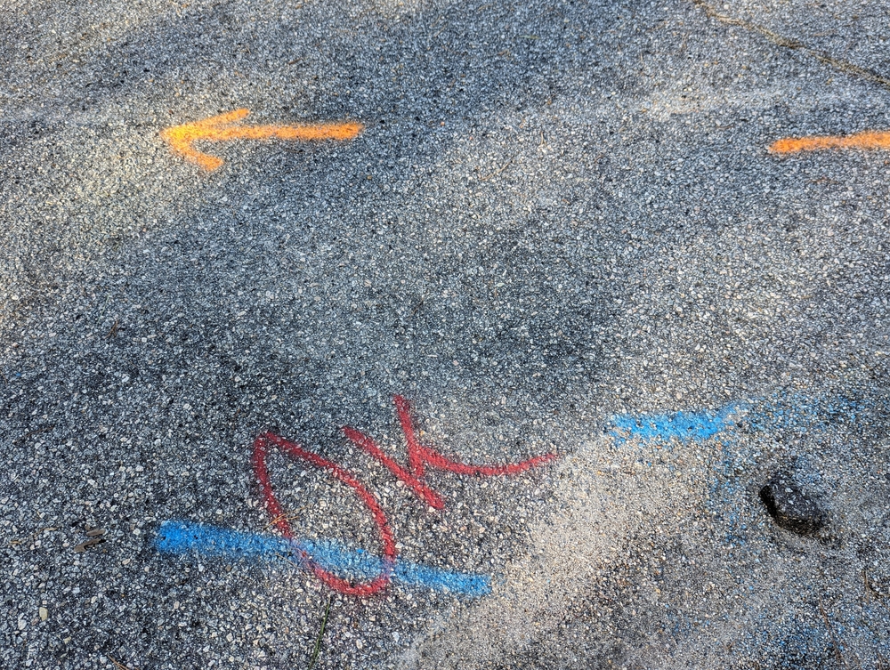 Underground,utilities,marked,with,spray,paint,on,roadway.,in,usa